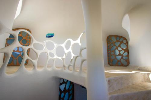 a staircase in a building with stained glass windows at Swan Villas in Maya Beach
