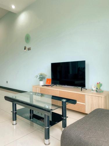 a living room with a flat screen tv on a entertainment center at Maison life 小居屋 The Loft Imago in Kota Kinabalu