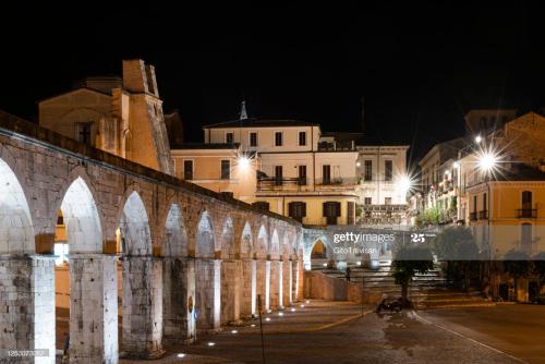 an old bridge in the city at night news photo at Dietro Piazza Maggiore in Sulmona