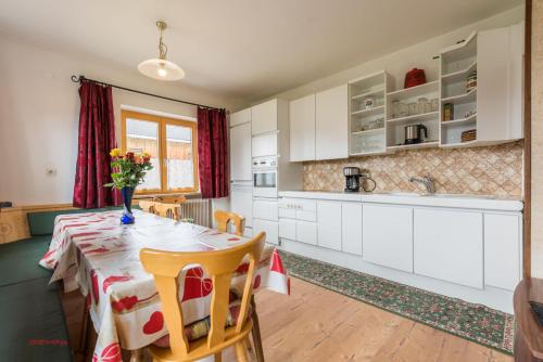 uma cozinha com uma mesa com um vaso de flores em Almliesl HOLL-304 em Hollersbach im Pinzgau