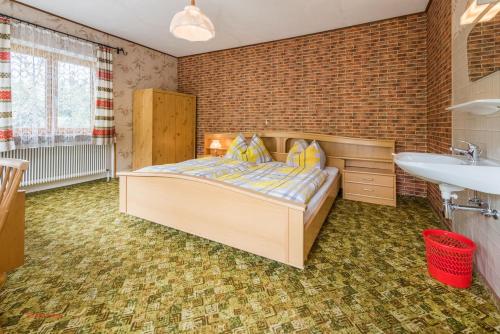 a bedroom with a bed and a sink at Almliesl HOLL-304 in Hollersbach im Pinzgau