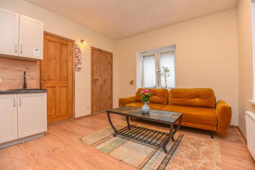 a living room with a couch and a table at KUBU Loft in Klaipėda