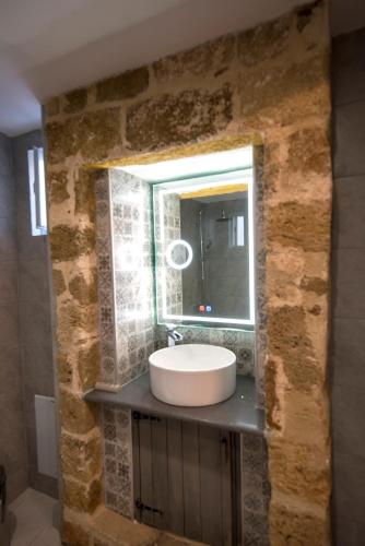 a bathroom with a sink and a mirror at Casa de Mikel in Rhodes Town