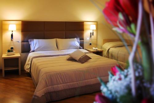 En eller flere senger på et rom på Hotel Ottagono