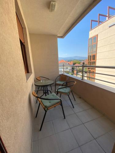 a balcony with two chairs and a table at Apartman Bozur in Vrnjačka Banja