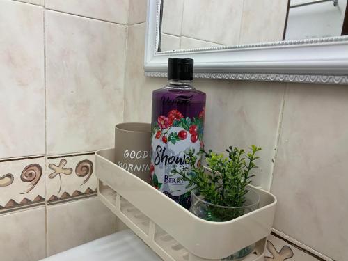 a bottle of wine sitting on a shelf in a bathroom at Cameron Highland Cozy Homestay in Tanah Rata