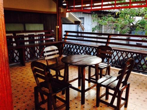 a table and chairs on a balcony with a table and chairs at Villa Vacay Chiang Mai in Chiang Mai