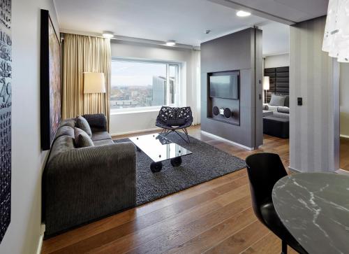 a living room with a couch and a table at Crowne Plaza Copenhagen Towers by IHG in Copenhagen