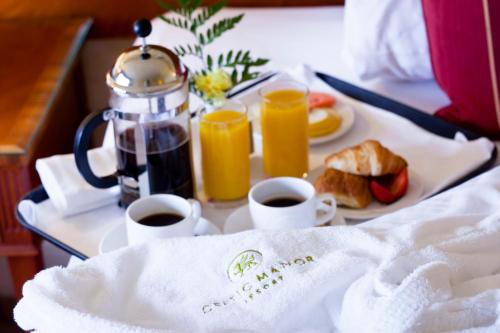 a tray of breakfast food with coffee and orange juice at The Celtic Manor Resort in Newport