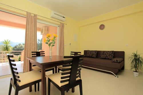 a living room with a table and chairs and a couch at D&A Apartments in Vela Luka
