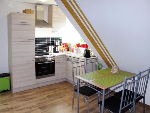 a kitchen with a table and chairs in a room at Apartment Scholz by Interhome in Born