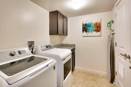 a white kitchen with a sink and a counter at 5I Cozy Family Friendly Moab Condo in Moab