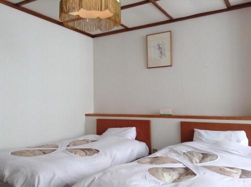 Postel nebo postele na pokoji v ubytování Resort Inn Chitose