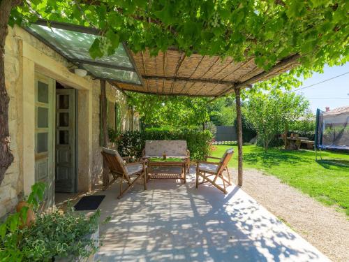 a patio with a table and chairs under a pergola at Holiday Home Hrelja - ROJ418 by Interhome in Žminj