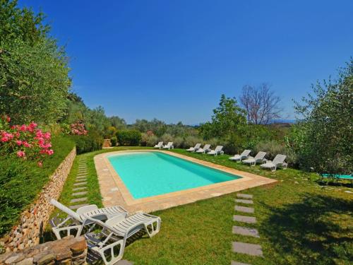 a swimming pool in a yard with lounge chairs at Holiday Home Casa delle Fiabe by Interhome in San Casciano in Val di Pesa