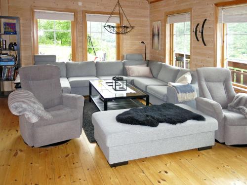 a living room with a couch and two chairs at Holiday Home Peer Gynt by Interhome in Sogndal