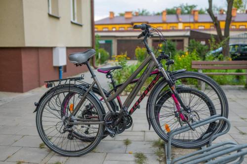 a bike is parked in a bike rack at Apartament Augustów SWAN in Augustów