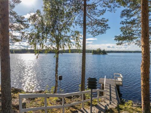 a dock on a lake with trees at Holiday Home Unnukkamaja by Interhome in Leppävirta