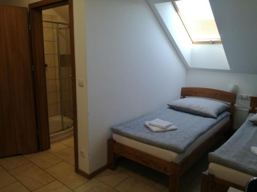 a small bedroom with a bed and a bathroom at U Justyny in Chróścice