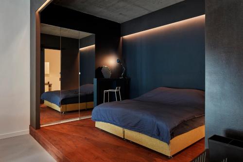 a bedroom with two beds and a large mirror at New beautiful design studio in Amsterdam West in Amsterdam
