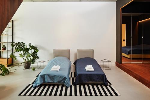 two beds on a rug in a room at New beautiful design studio in Amsterdam West in Amsterdam