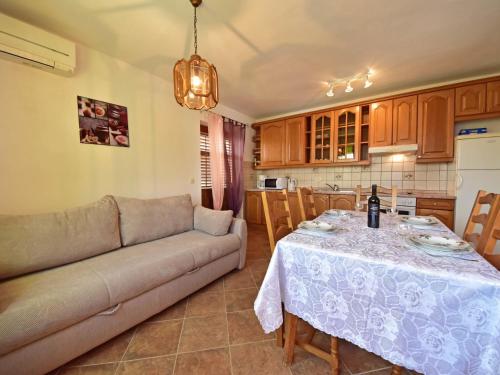 a living room with a table and a couch at Apartment Villa Karolina by Interhome in Opric