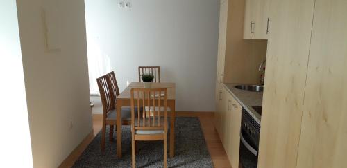 a kitchen with a table and chairs in a room at As Casinhas dos avós by Quinta do Paço in Amarante