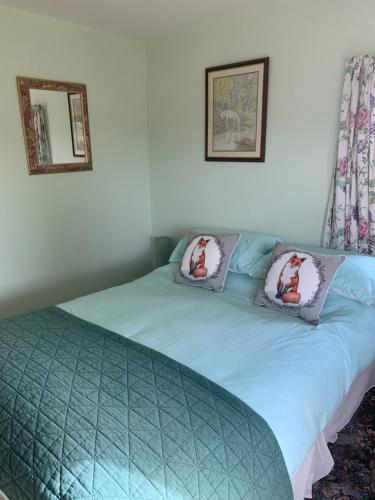 a bedroom with two beds with pillows on them at High Greenside in Kirkby Stephen