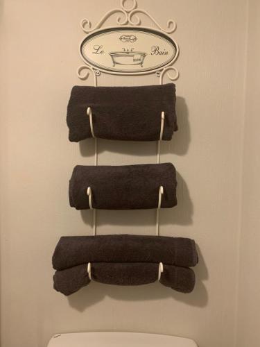 a row of towels hanging on a rack above a toilet at High Greenside in Kirkby Stephen
