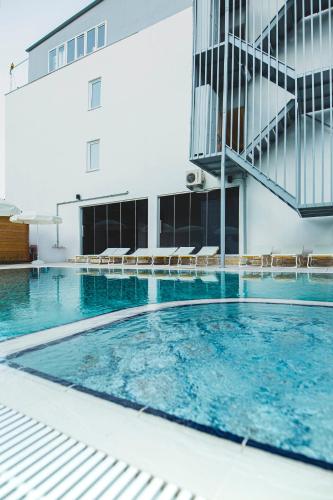 a swimming pool in front of a building at Belsun Hotel in Beldibi