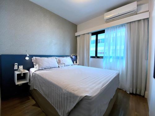 Tempat tidur dalam kamar di Apartamento conforto - Itaim Bibi