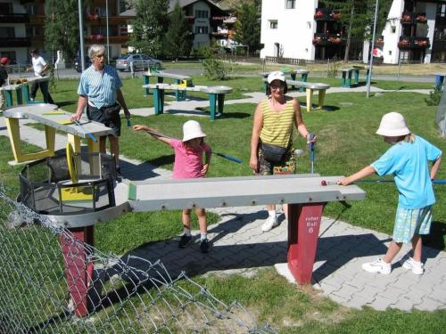 a group of people playing ping pong in a park at Apartment Haus Alpenrose by Interhome in Saas-Almagell