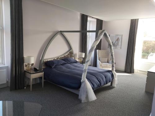 a bedroom with a bed with a swing at Dean Park Hotel in Kirkcaldy
