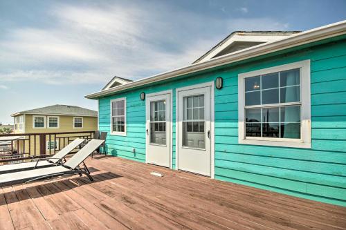 a blue house with a deck with a bench at half Mi to Sand Surfside Beach Retreat! in Surfside Beach