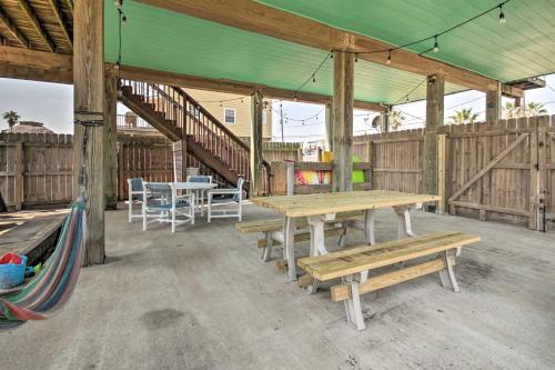 a patio with wooden benches and tables and stairs at half Mi to Sand Surfside Beach Retreat! in Surfside Beach