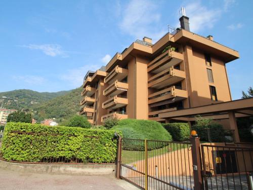 a building with a fence in front of it at Apartment La Perla di Laveno by Interhome in Laveno-Mombello