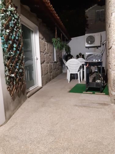 a patio with a table and a bunch of wine bottles at As casinhas dos meus Avós by Quinta do Paço in Amarante