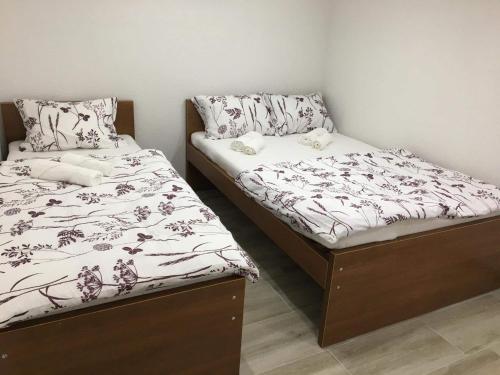 two beds sitting next to each other in a room at Apartman “Centar Jajce “ in Jajce