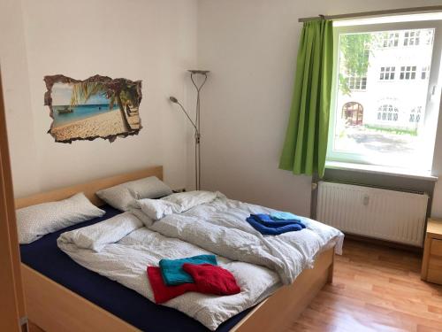 a bedroom with a bed with two towels on it at Ruhige Wohnung bei der Burg im OG2 in Kröllwitz