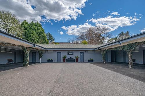 an empty parking lot in front of a building at Cotswold Gardens in Armidale