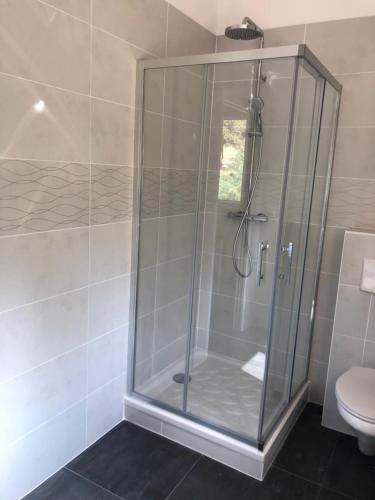 a shower stall in a bathroom with a toilet at L'Oliveraie in La Londe-les-Maures