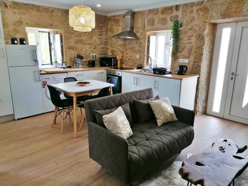 a living room with a couch and a table at Cantinho D'Aldeia in Guarda