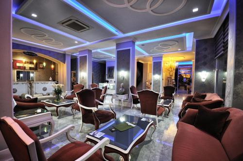 a lobby with couches and chairs and a table at Grand Atakum Hotel in Samsun