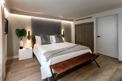 a bedroom with a large bed with a wooden floor at La Jolla Cove Suites in San Diego