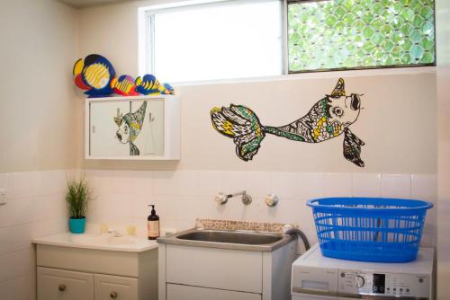 a kitchen with a sink and a dog on the wall at Yanchep Hacienda by the Sea in Yanchep