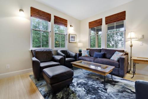 a living room with a couch and chairs and windows at 3 Bed 3 Bath Vacation home in Eastsound in Eastsound