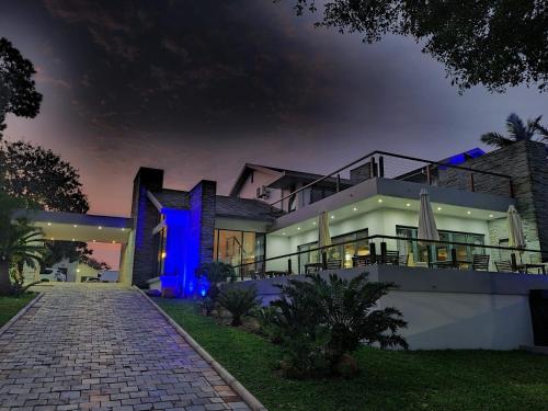 una casa grande con una luz azul por la noche en St Lucia Hilltop Guest House, en St Lucia