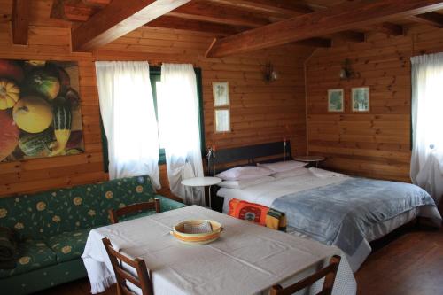a bedroom with a bed and a table and a couch at Villa Clementine in Piazza Armerina