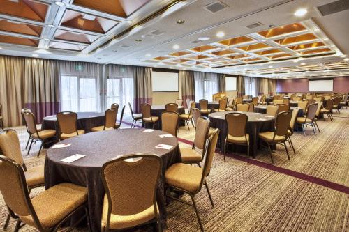a large room with tables and chairs in it at Crowne Plaza Kitchener-Waterloo by IHG in Kitchener