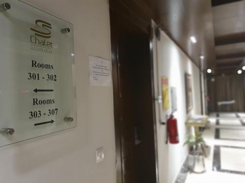 a sign on the wall of a room with a room at S Chalet Islamabad in Islamabad